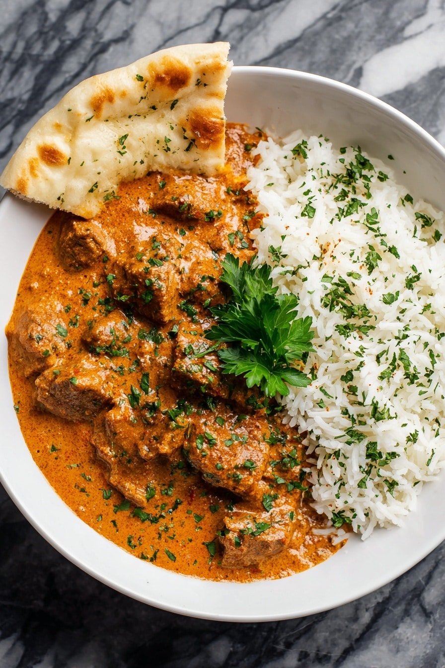A white bowl holds a dish with two main layers side by side; on the left is a thick, creamy orange sauce with chunks of food covered in finely chopped green herbs, and on the right is a fluffy white rice layer sprinkled lightly with green herbs. In between, a small bunch of fresh green parsley sits on top of the sauce. Behind the bowl, there is a piece of flatbread with green herbs resting on a white marbled surface. Photo taken with an iphone --ar 2:3 --v 7 — Easy Homemade Butter Chicken, homemade butter chicken recipe, quick butter chicken, creamy butter chicken, Indian butter chicken