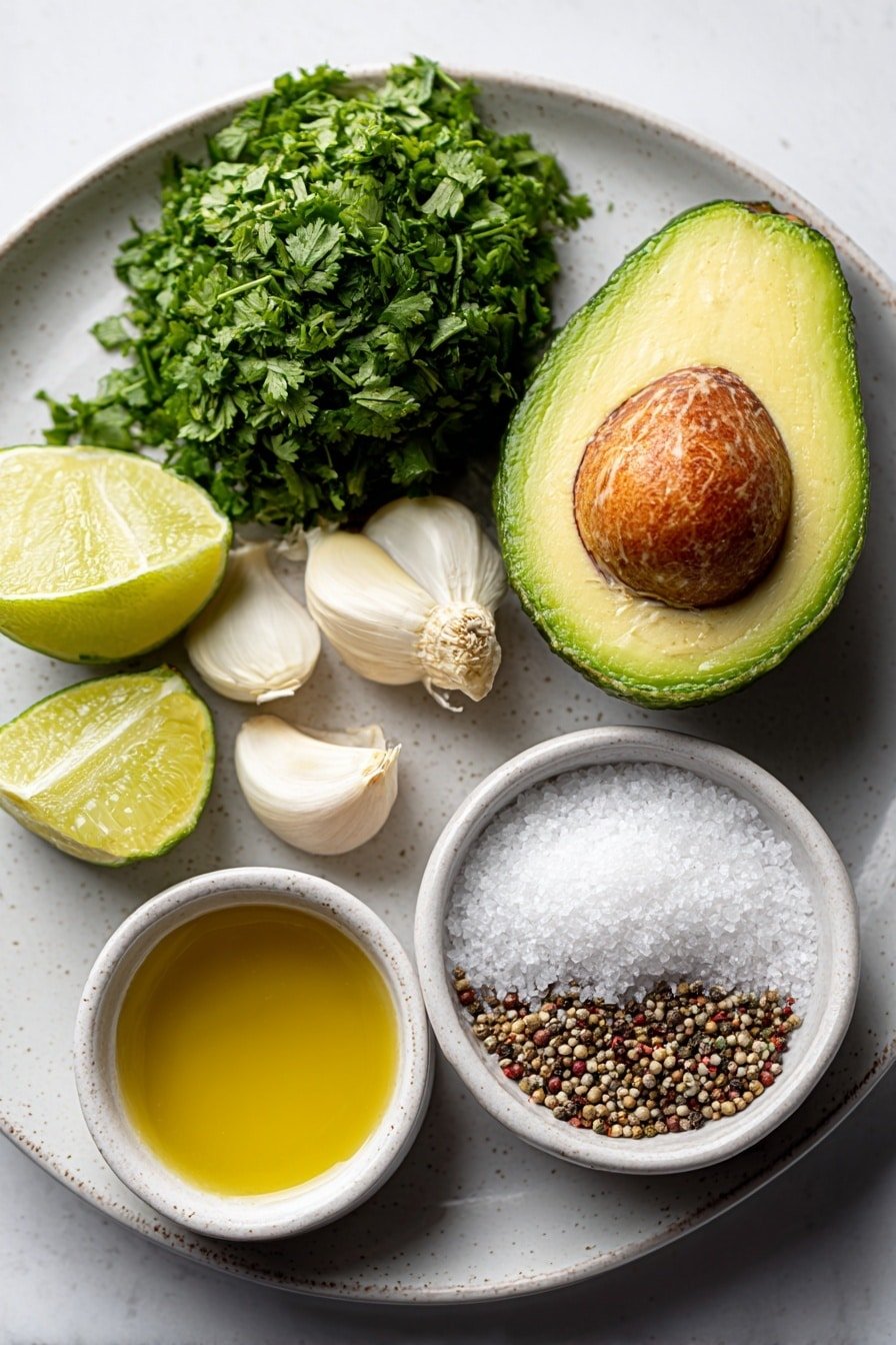 Flat lay of a halved ripe avocado with the pit removed, a medium bunch of fresh cilantro with stems trimmed, two peeled garlic cloves, two halved medium limes, one halved jalapeño pepper with seeds removed, a small white ceramic bowl of coarse kosher salt, a small white ceramic bowl of golden olive oil, and a small white ceramic bowl of mixed black and white peppercorns, all arranged symmetrically on a simple white ceramic plate, placed on a clean white marble surface, soft natural light, photo taken with an iPhone, professional food photography style, fresh ingredients, white ceramic bowls, no bottles, no duplicates, no utensils, no packaging --ar 2:3 --v 7 --p m7354639359234015250 — Cilantro Lime Dressing, homemade salad dressing, healthy dressing recipes, fresh lime dressing, easy cilantro lime sauce